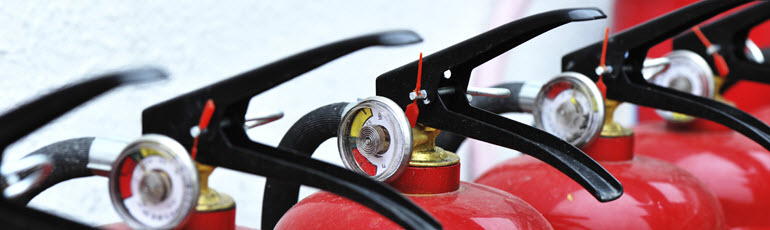 Close up of a line of fire extinguishers.